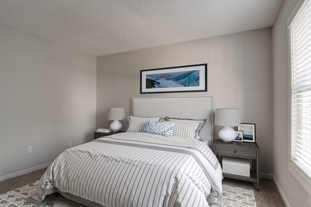 Bedroom at Mirador at Idlewood in Clarkston, Georgia, featuring large windows that provide abundant natural light.