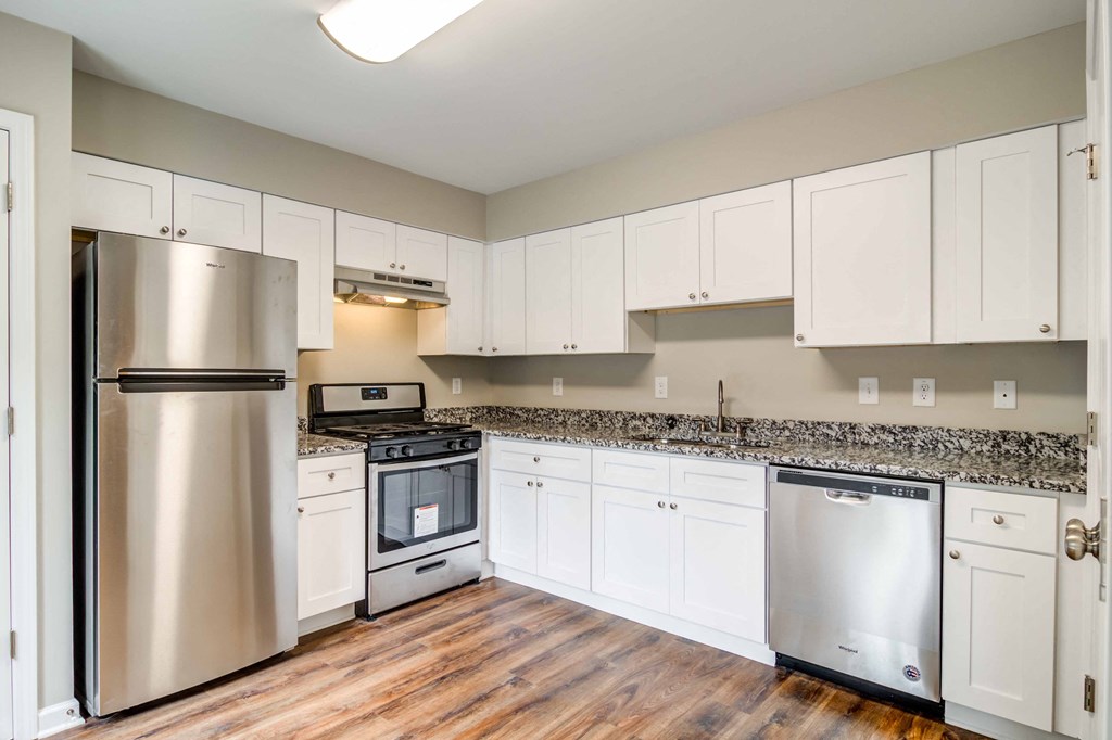 Mirador at Idlewood Apartments in Clarkston Georgia photo of kitchen with white cabinets and stainless steel appliances