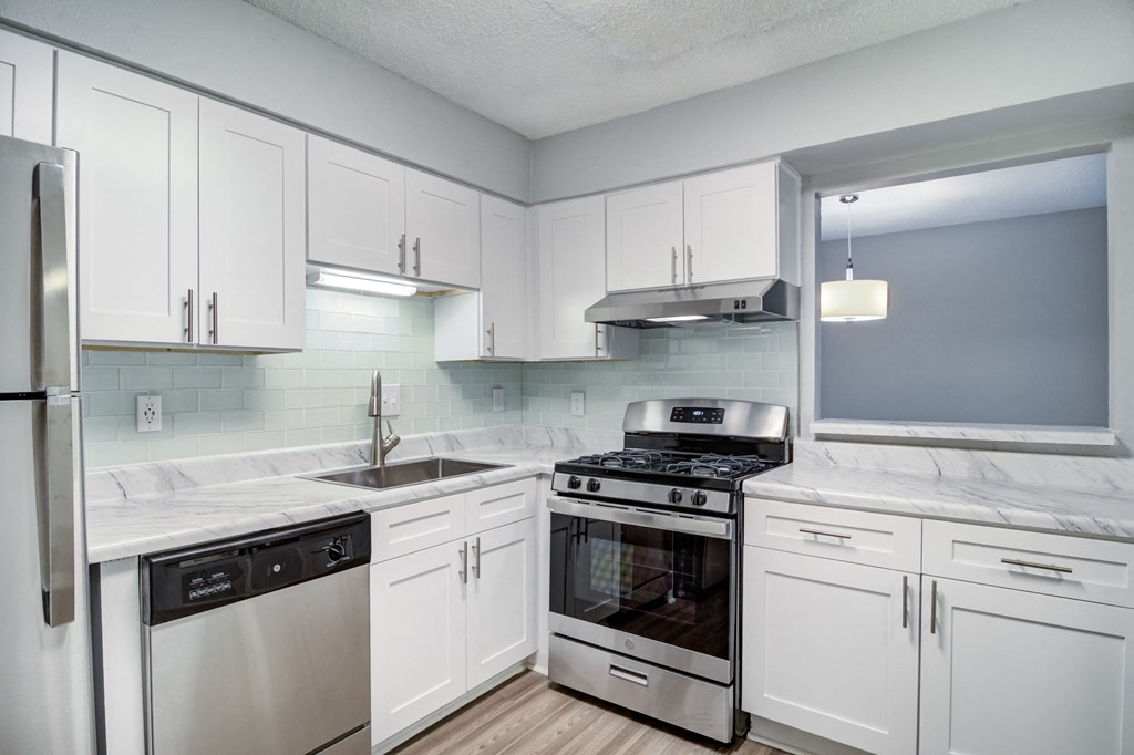 Mirador at Idlewood Apartments in Clarkston Georgia photo of view of kitchen with stainless steel appliances and white cabinets