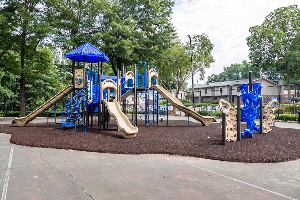Colorful playground with slides and swings at Mirador at Idlewood Apartments near Stone Mountain and Kirkwood