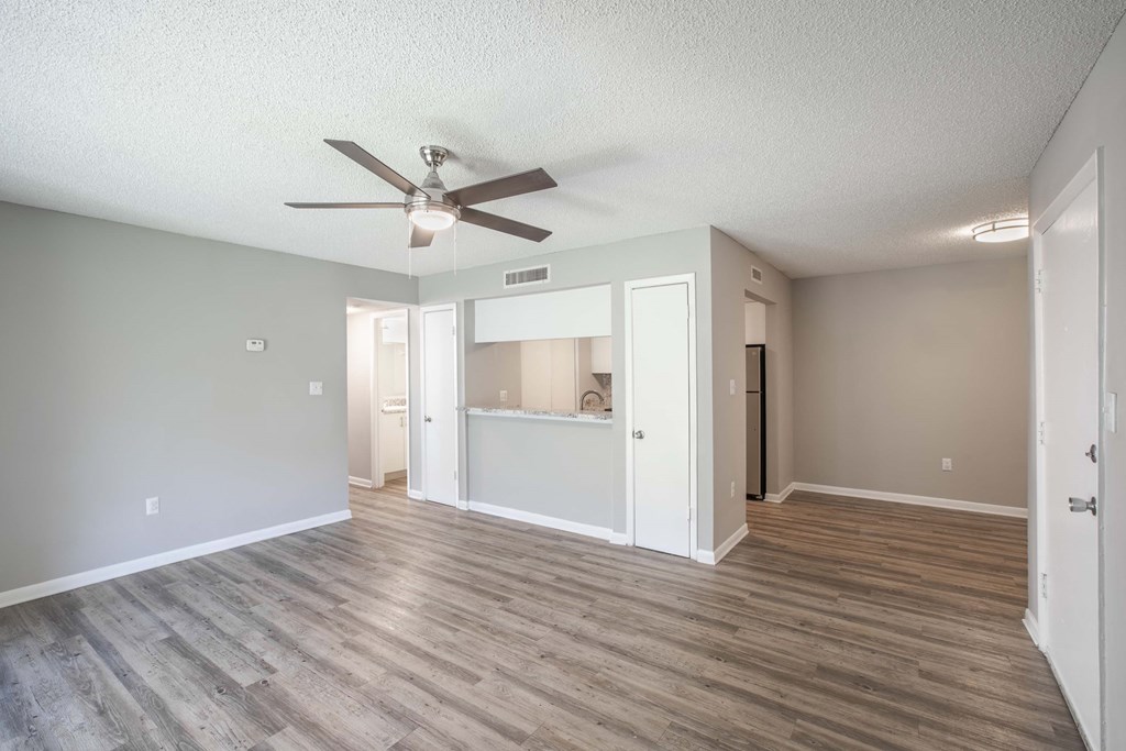Pet-Friendly Apartments in Kissimmee, FL- Mirador at Woodside - Living Room and Dining Room with Woodstyle Flooring