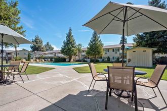 Gilroy Apartments for Rent - Mission Park - Outdoor Lounge Area With Seating, Tables, and Umbrellas Near the Swimming Pool