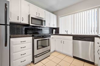 Apartments for Rent in Gilroy CA - Mission Park - Modern Kitchen with Stainless Steel Appliances and White Cabinetry