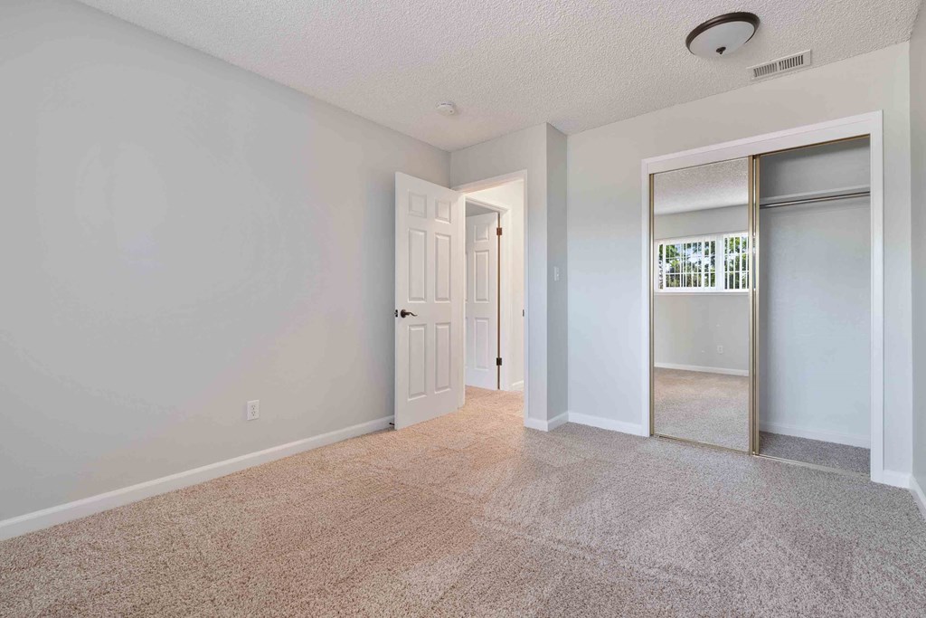 Gilroy, CA Apartments For Rent - Mission Park - Spacious Bedroom With Wall-to-wall Carpeting, and Large Closet With Mirror Sliding Doors
