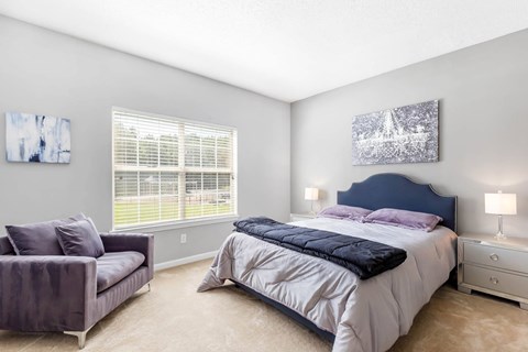 a bedroom with a bed and a chair