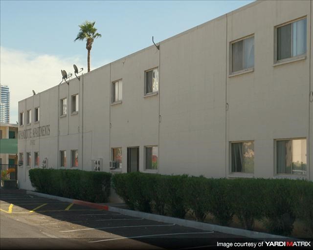 a large white building with a palm tree in front of it