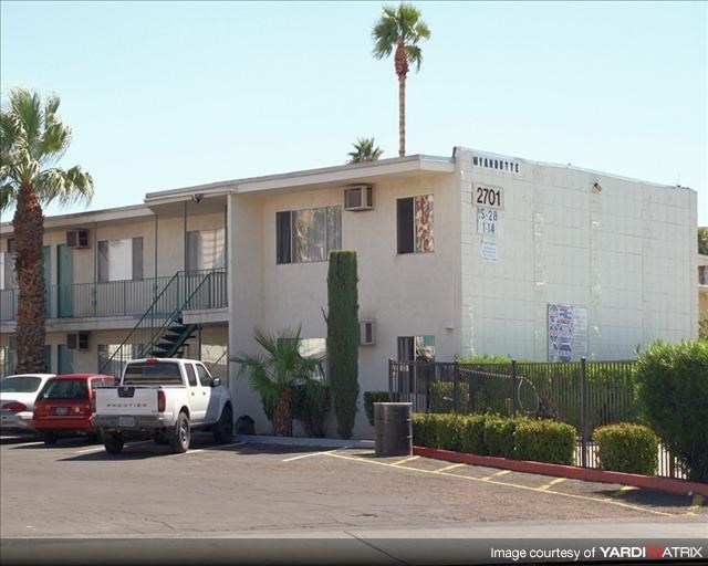 a white building with a truck parked in a parking lot