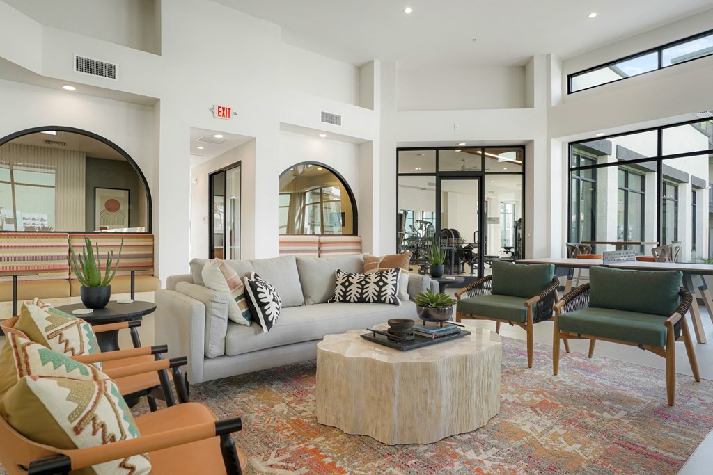 a living room with a couch and chairs and a coffee table