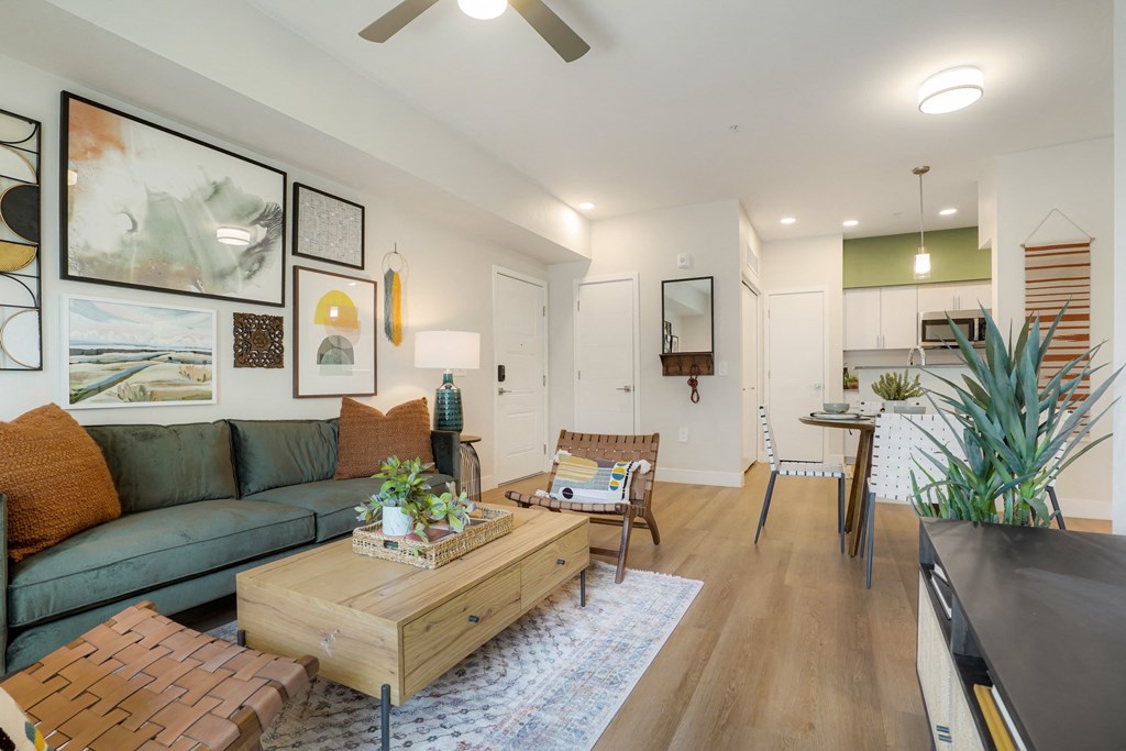 Glendale, AZ Luxury Apartments - Nacona - Living Room With Couch, Coffee Table, Area Rug, Ceiling Fan, And Modern Decor.