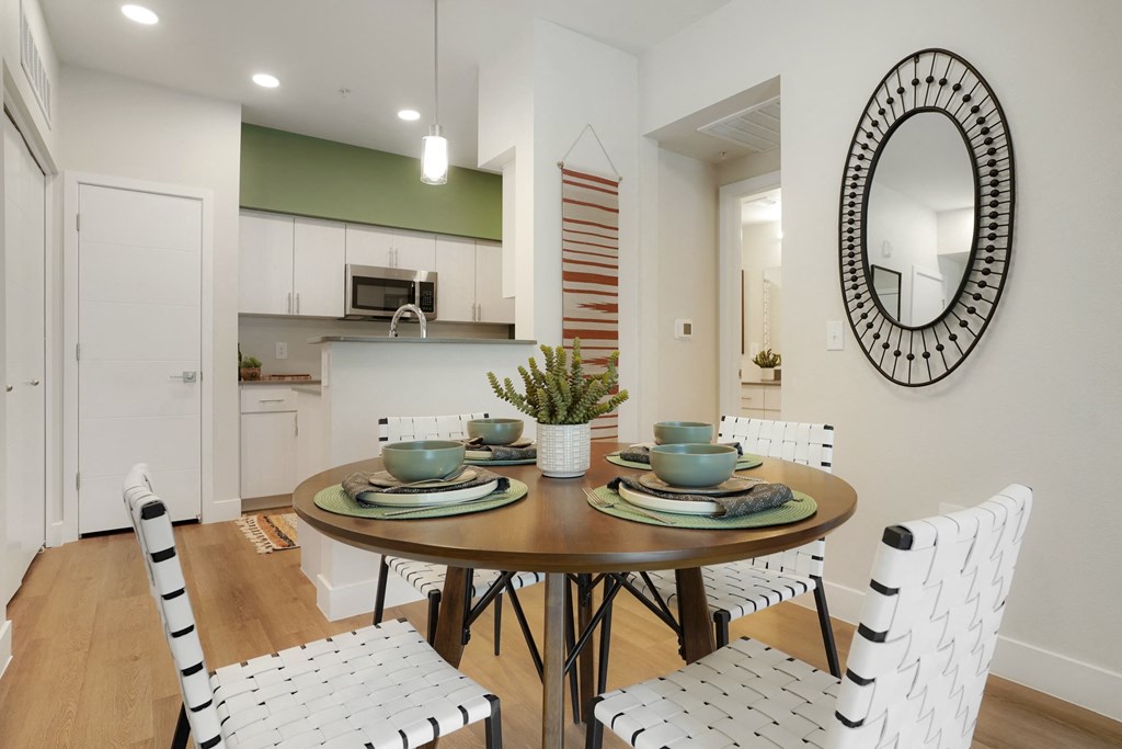 a dining room with a table and chairs and a kitchen