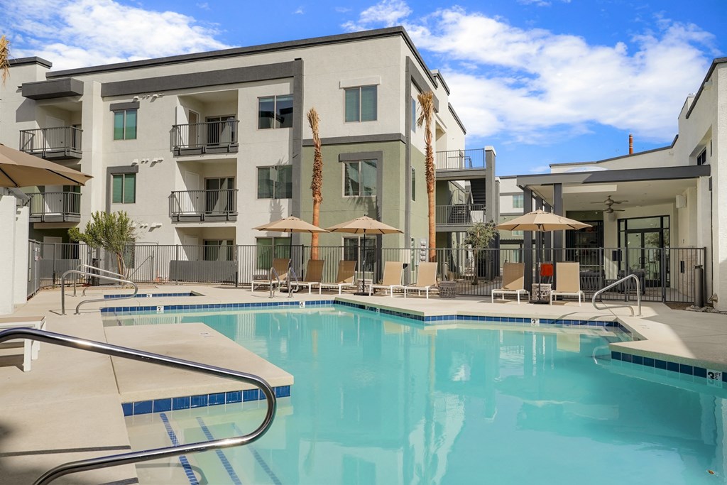 Glendale, AZ Luxury Apartments Near Westgate Entertainment District - Nacona - Sparkling Pool With Patio Furniture, Umbrellas, And A Spa.