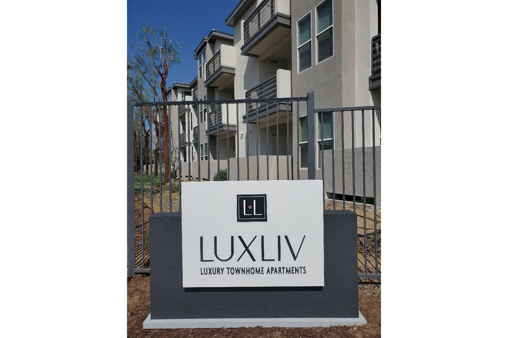 a sign in front of an apartment building