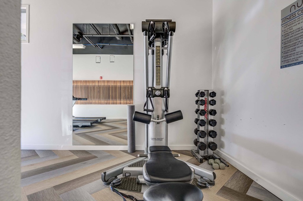 a gym with a machine in the corner of a room