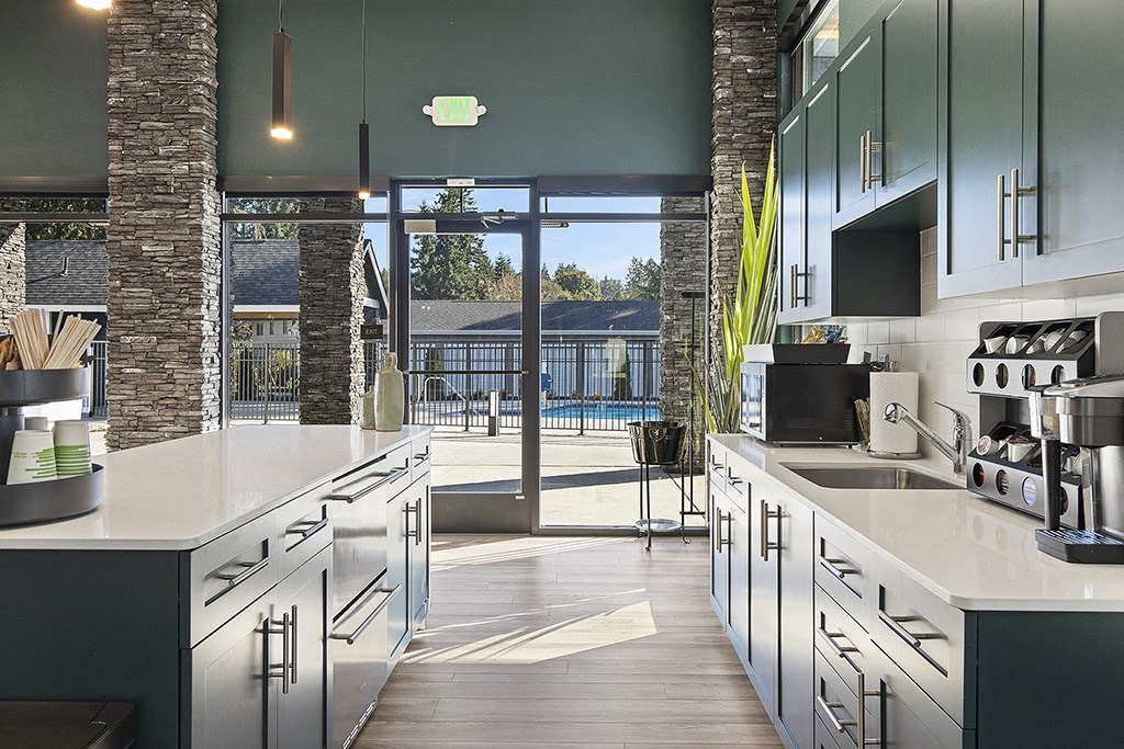 a large kitchen with stainless steel appliances and a sliding glass door leading to a pool,