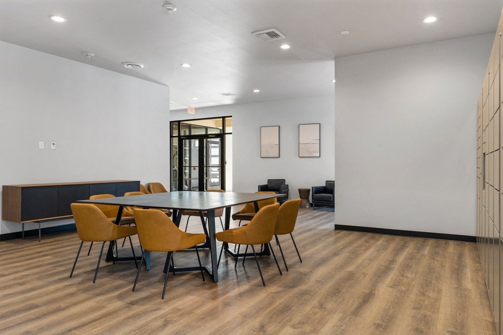 a room with a large table and chairs,