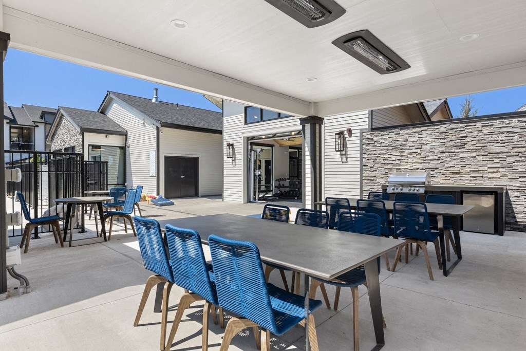 Port Orchard, WA Apartments - Belfair View - BBQ Area with Grill Station and Dining Tables.