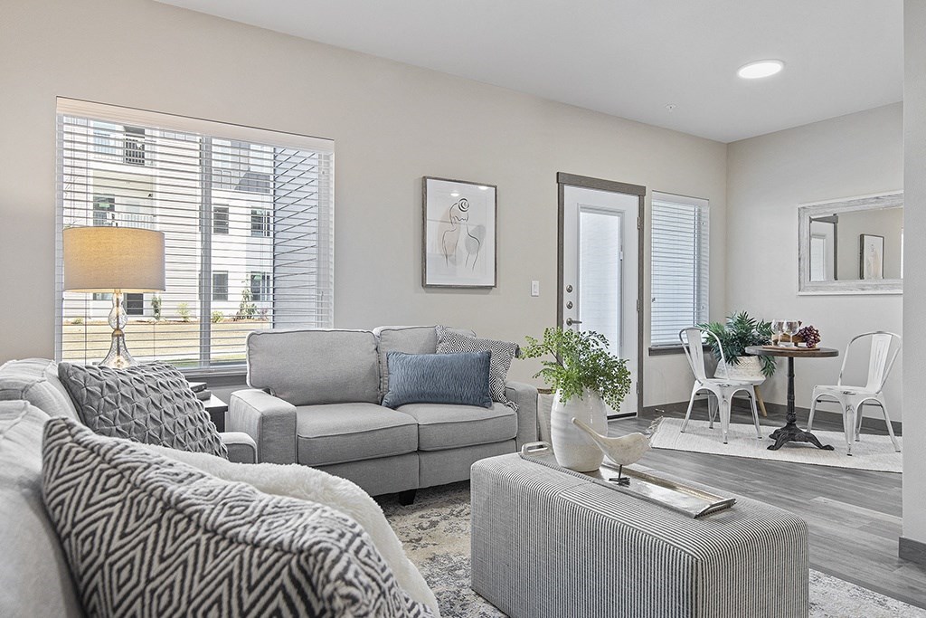 a living room with a couch and a chair and a table,
