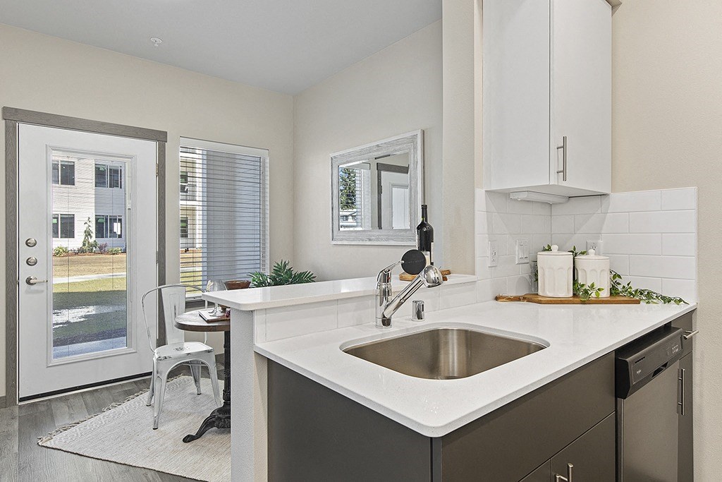 an open kitchen with a sink and a door to a patio,