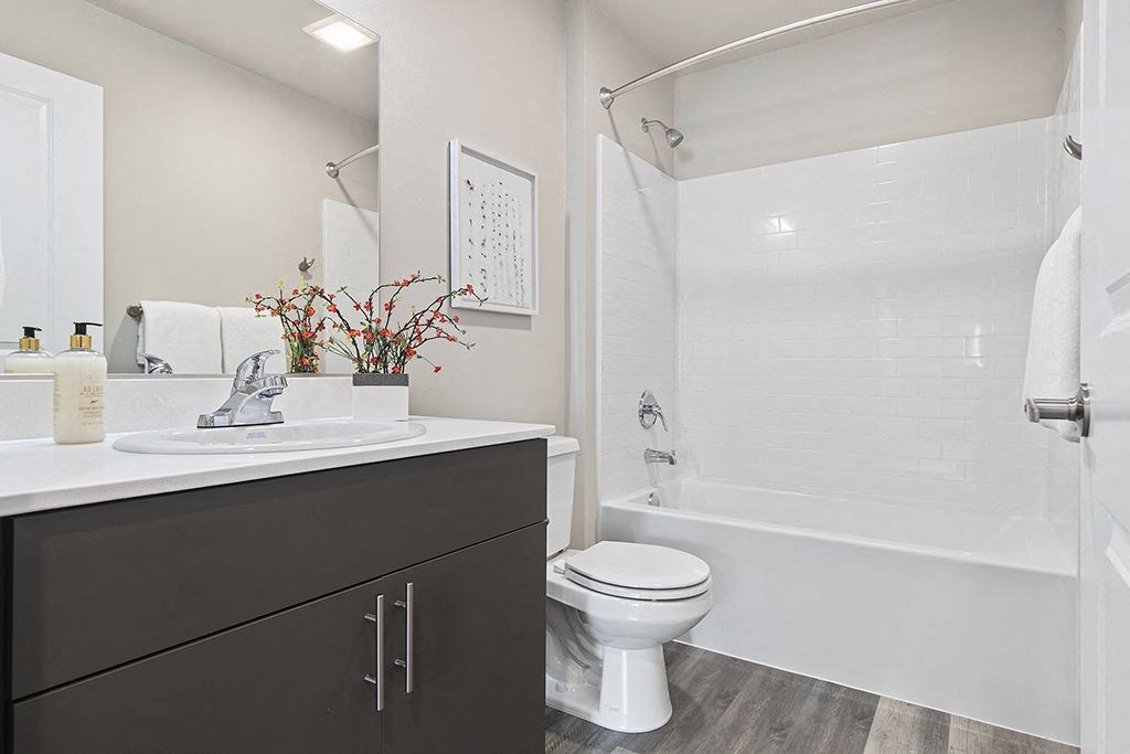 a bathroom with a sink toilet and a shower,