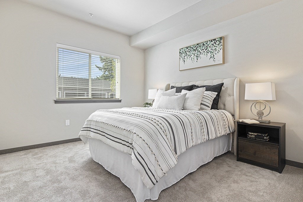 a spacious bedroom with a bed and nightstand,