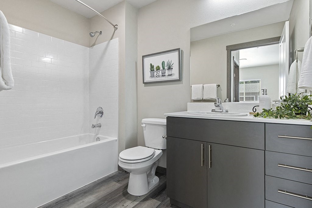 a bathroom with a toilet and a bath tub,