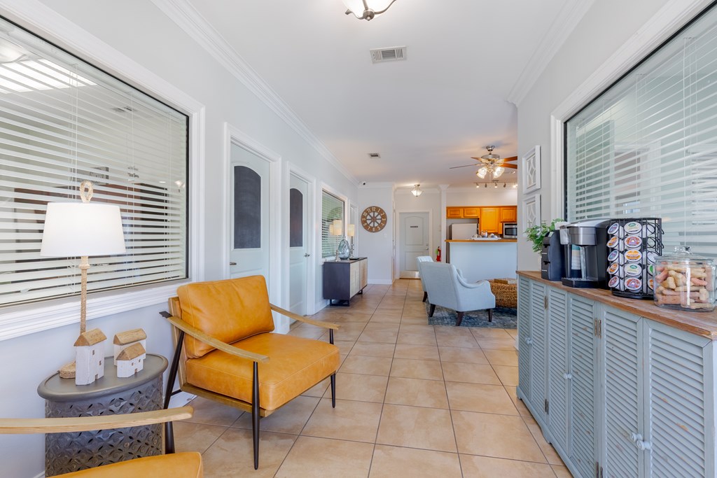 A living room with a yellow chair and a grey cabinet.