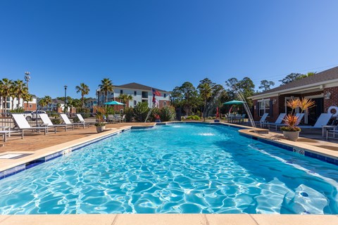 A large swimming pool with a blue tiled edge and a white tiled edge.