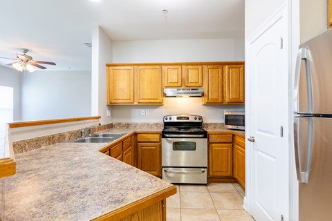 A kitchen with wooden cabinets and stainless steel appliances.