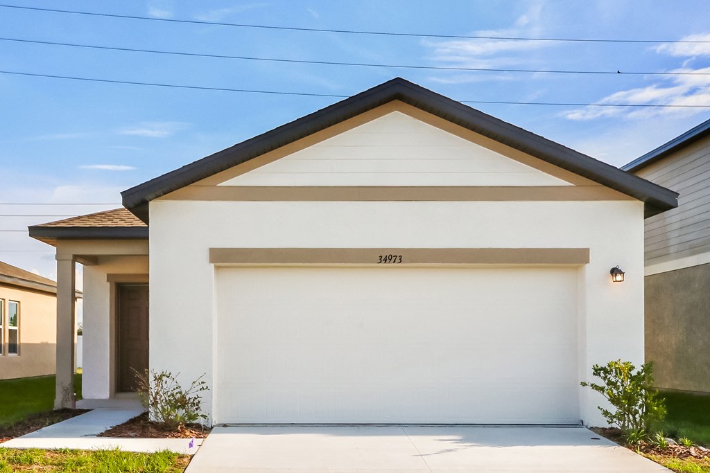 A white garage door with the number 34973 on it.