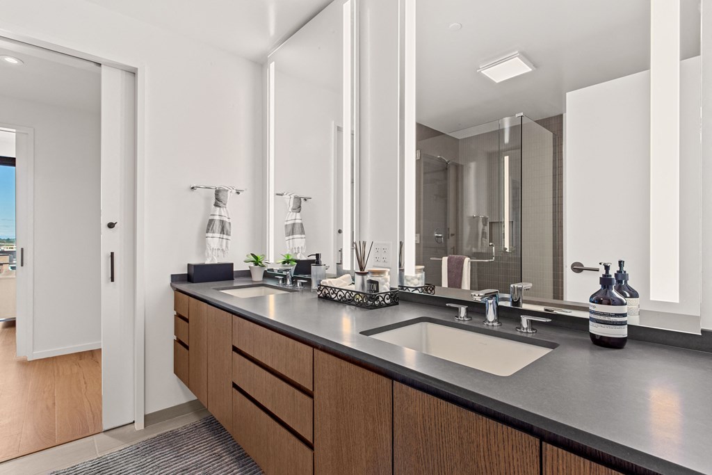 a bathroom with two sinks and a large mirror