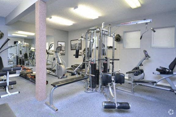 a gym with a lot of exercise equipment in it