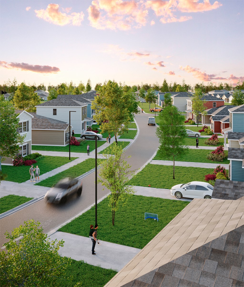 an aerial view of a neighborhood with cars driving down the road and people walking on the sidewalk