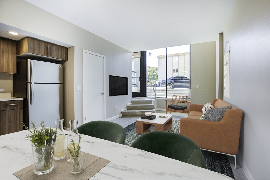 a living room with a kitchen and a couch and a table