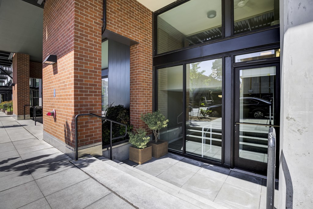 the entrance to a brick building with glass doors