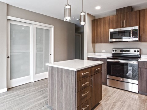 a kitchen with stainless steel appliances and wooden cabinets