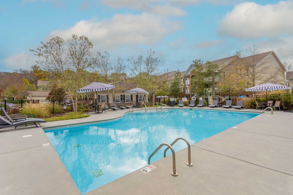 One, Two and Three- Bedroom Apartments for Rent in Sevierville, TN – Overlook at Allensville – A large swimming pool with seating areas and umbrellas