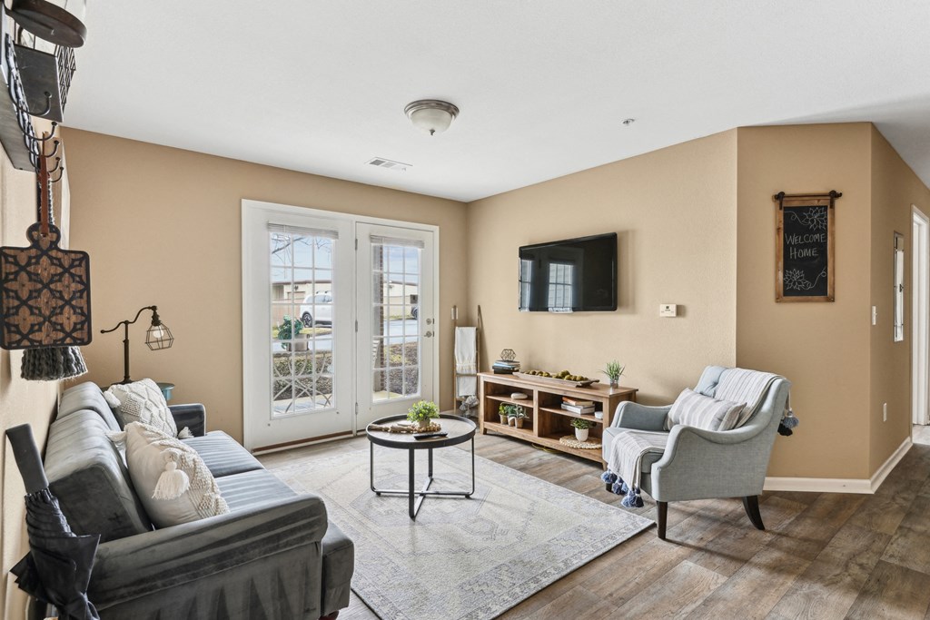 Pet-Friendly Rentals in Sevierville, TN – Overlook at Allensville – A living room with a grey couch, a coffee table, a chair, and a lamp.