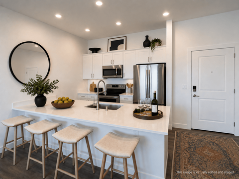 A kitchen with white cabinets and a white counter top.