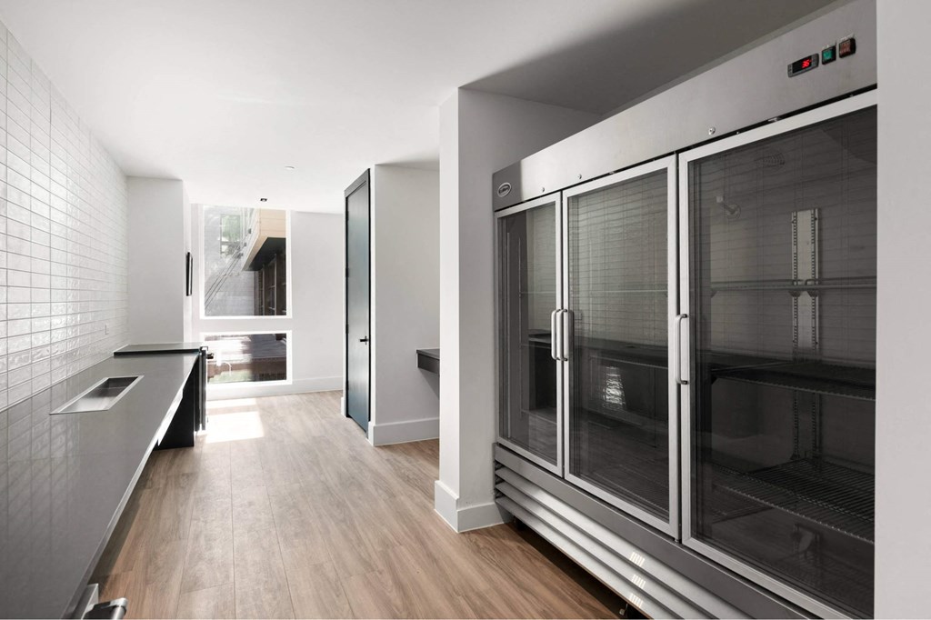 A modern kitchen with a large oven and a tiled wall.