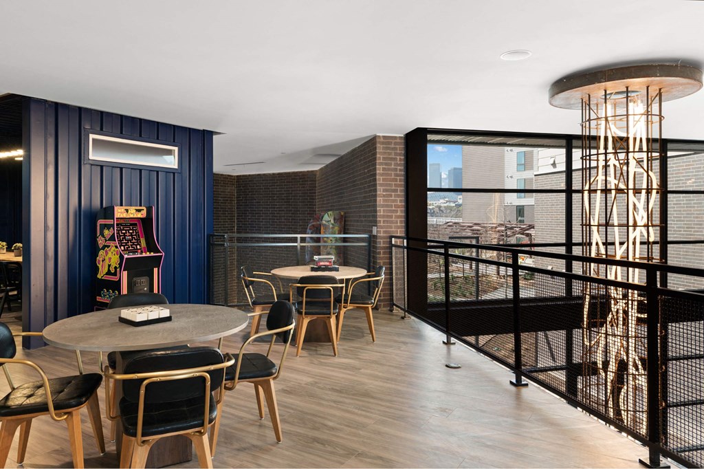 A modern sitting area with a round table and chairs.