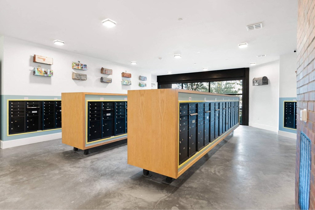 Large open room with postal boxes inside The Laura postal center.