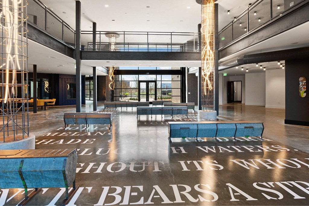 A large open room inside The Laura office with a floor that has a quote on it.