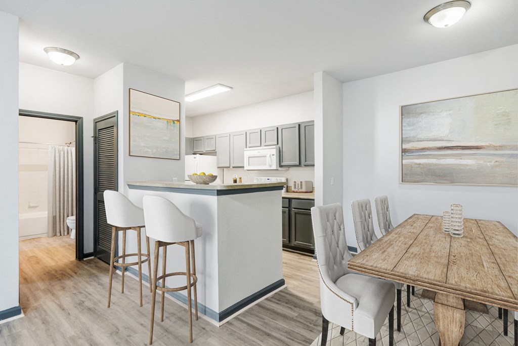 Nashville, TN Apartments - Parc at Metro Center - kitchen with breakfast nook and barstools and dining room