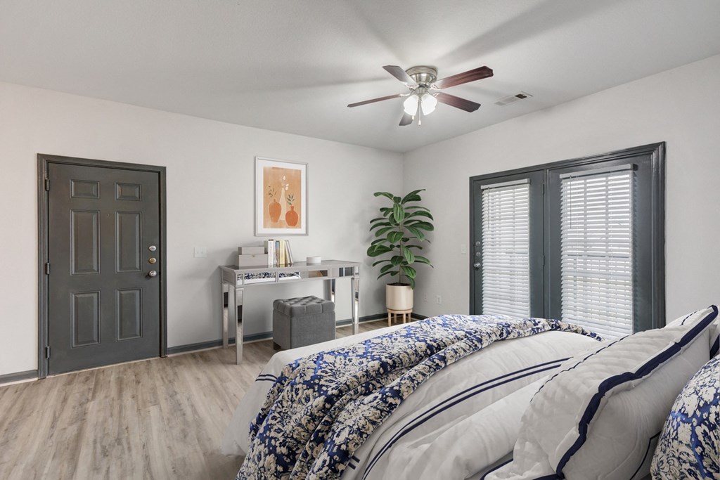 Pet-Friendly Apartments in Nashville, TN - Parc at Metro Center - Bedroom with ceiling fan and french doors to  patio/balcony