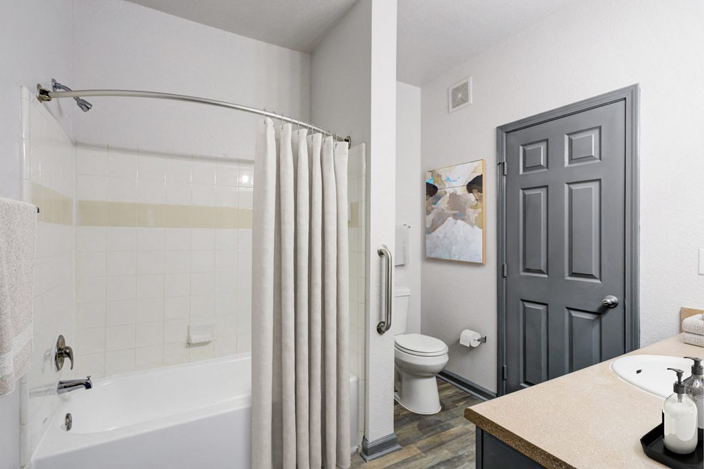 Pet-Friendly Apartments in Nashville, TN - Parc at Metro Center - Bathroom with tub and shower curtain