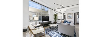a living room with white walls and hardwood floors