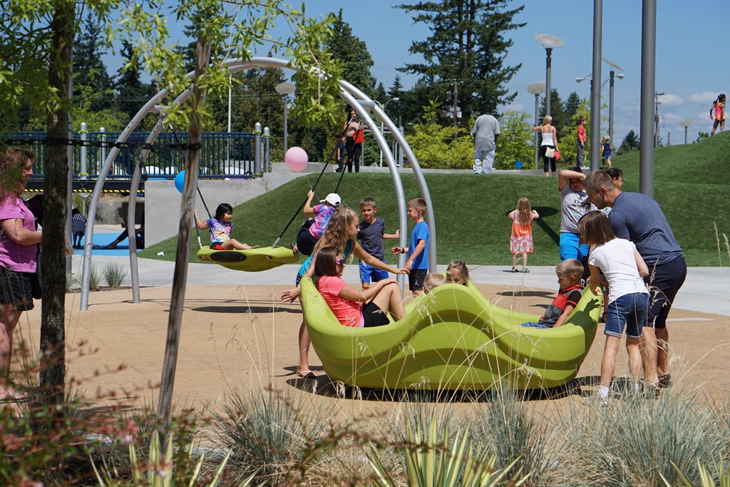 people playing on a playground at a park