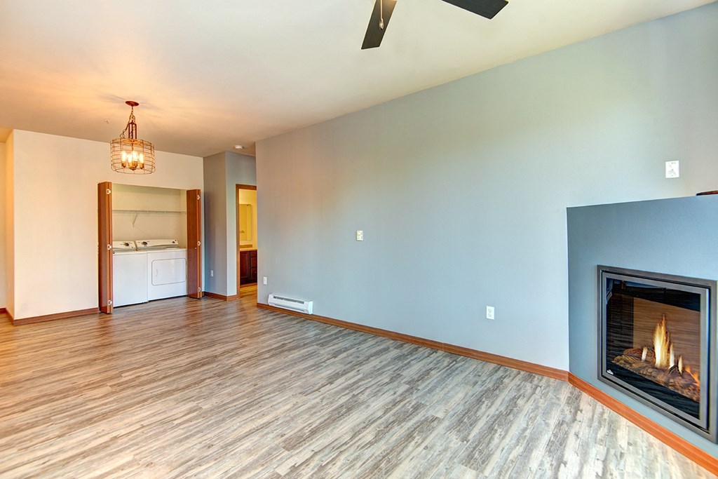 a living room with a fireplace and a wooden floor