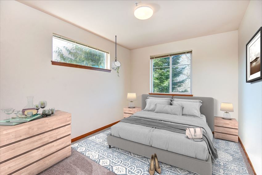 a bedroom with a bed and two windows