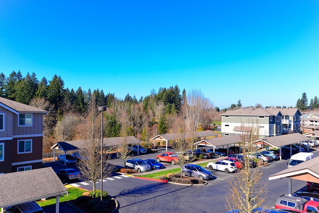 an aerial view of a neighborhood with cars parked in a parking lot